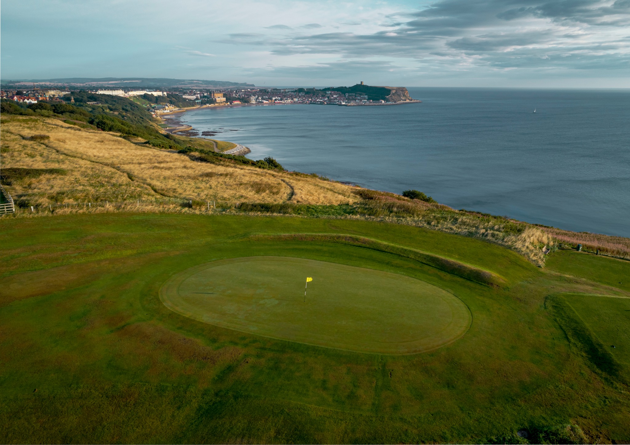 Image of golf ball on tee on grass.